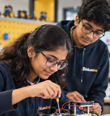 Student soldering a robot car