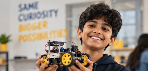 Student holding his robot car